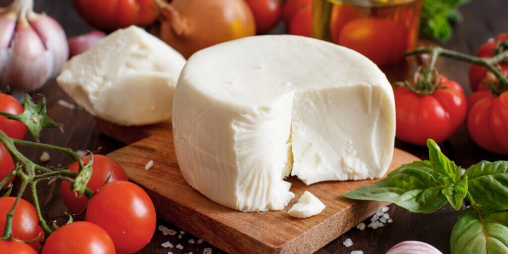 South Italian cheese cacioricotta with vegetables, herbs and olive oil close up. South italian food concept